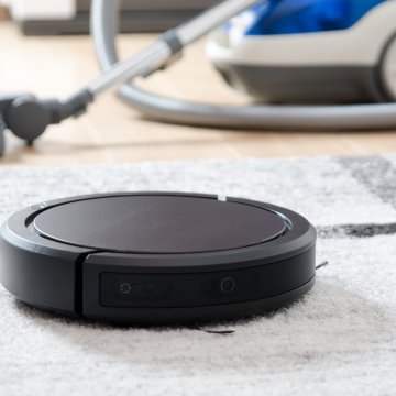 robot vacuum cleaners black vacuum on the carpet traditional vacuum cleaner